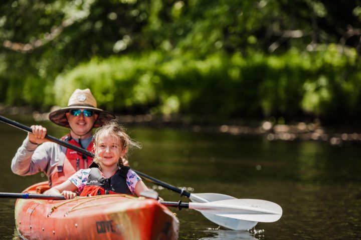 a person riding on the back of a boat in the water