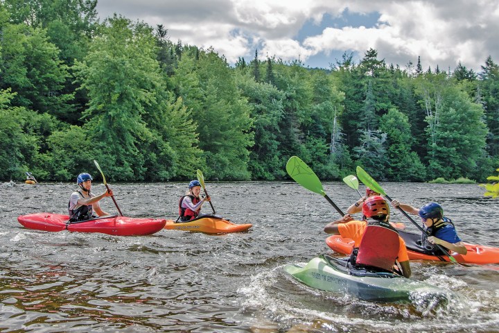 a group of people on a raft in a body of water