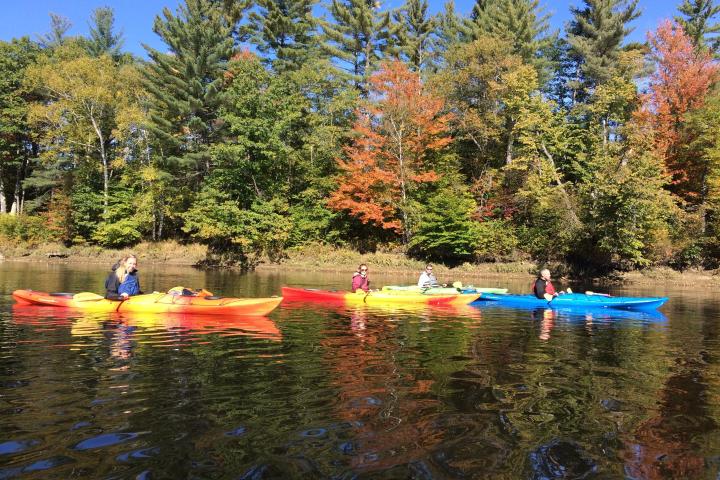 a group of people in a small boat in a body of water