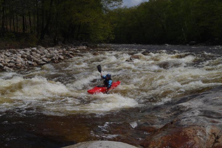 a man riding a wave on top of a river