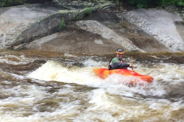 a man riding a wave on top of a river