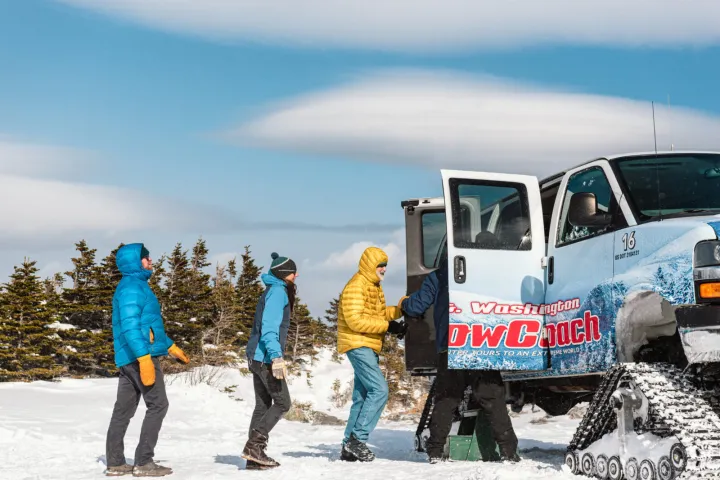 a couple of people that are standing in the snow