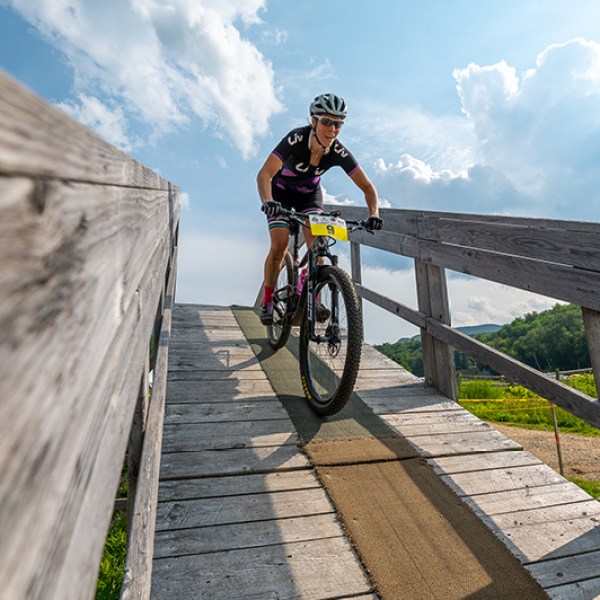 a man riding a bike down a dirt road