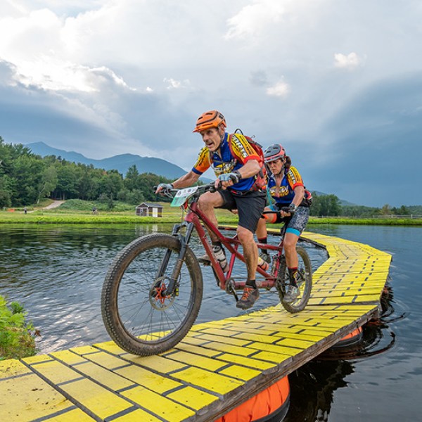 a man riding on the back of a boat in a body of water
