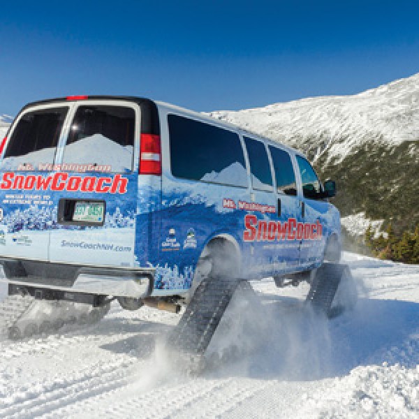 a person riding a snowboard down a snow covered mountain
