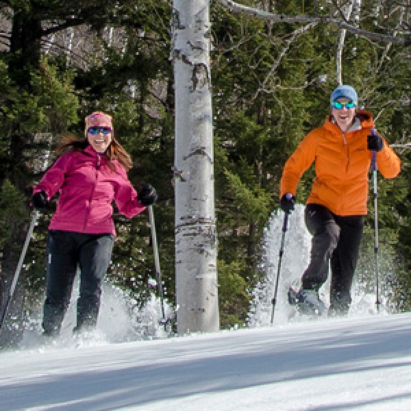 a group of people cross country skiing in the snow