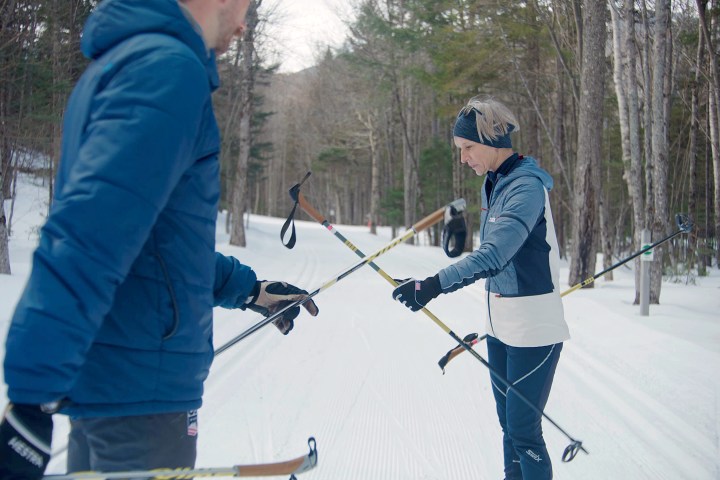 a person riding skis down a snow covered slope