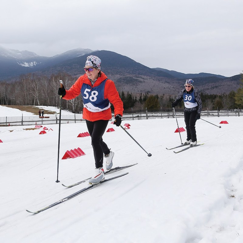 a person riding skis down a snow covered slope