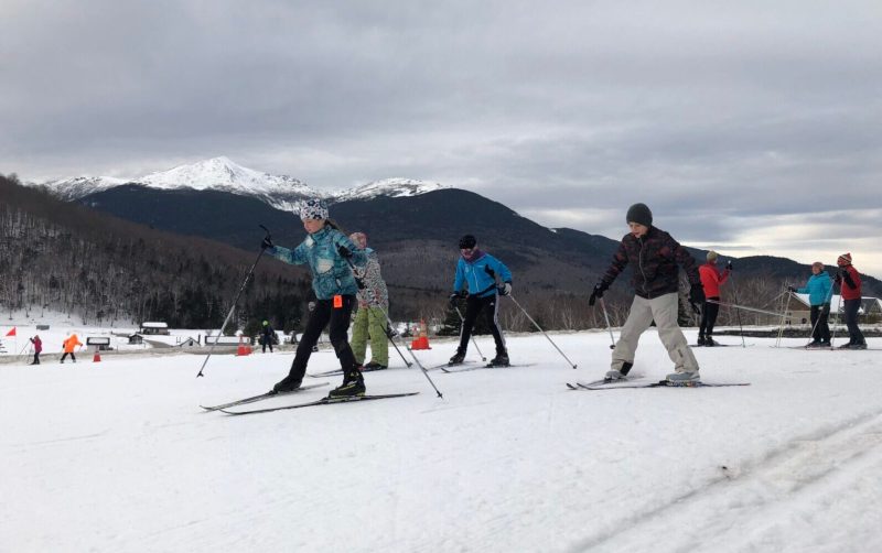 BKLKids2 a group of people riding skis down a snow covered slope