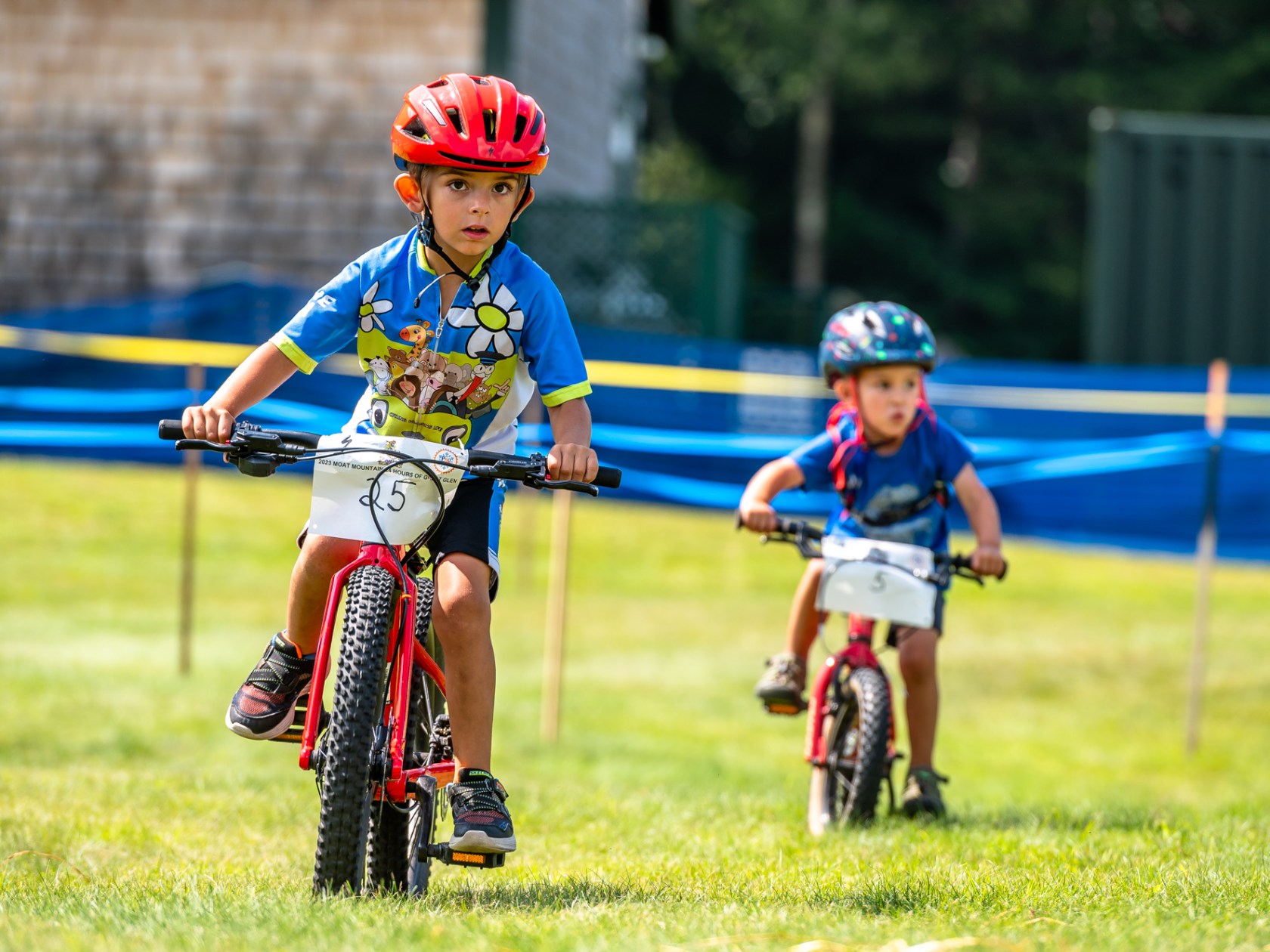 a young child riding a bicycle on a baseball field