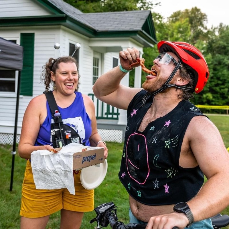 a couple of people that are standing in the grass