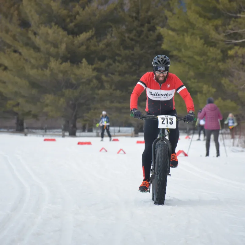 a man riding skis down a snow covered slope