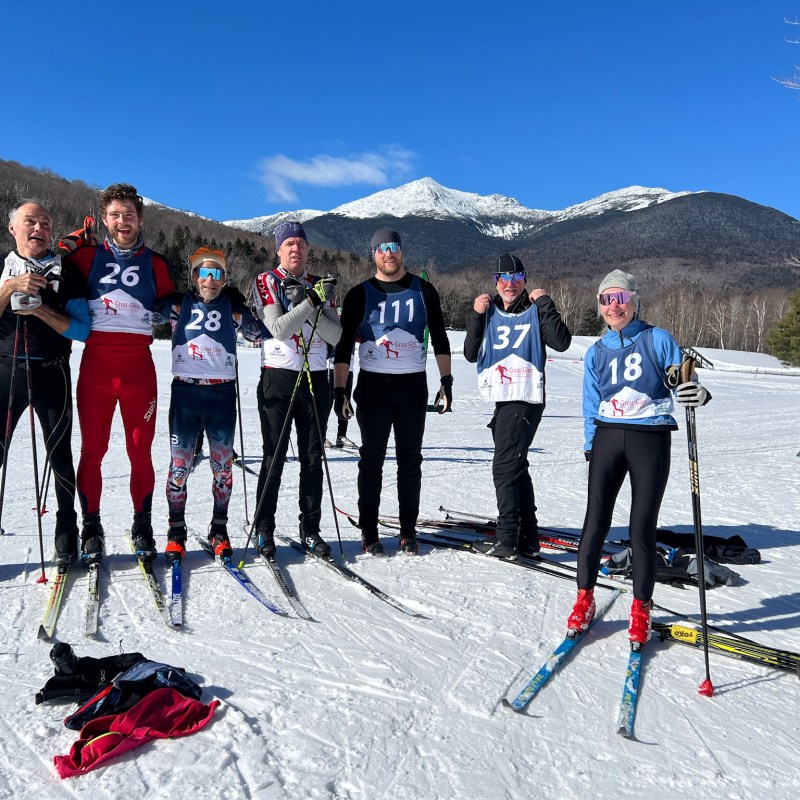 a group of people posing for a picture while skiing