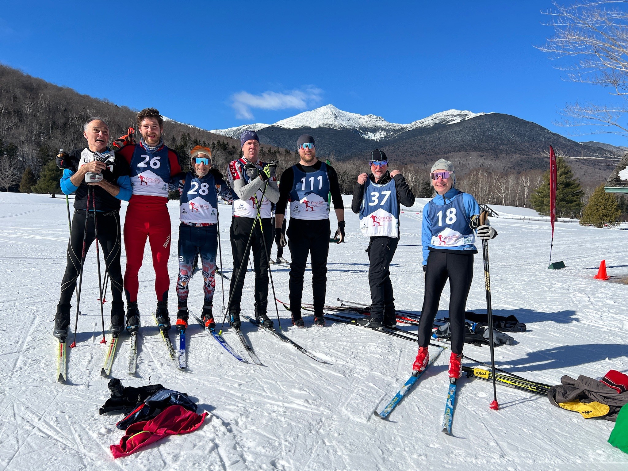 a group of people posing for a picture while skiing