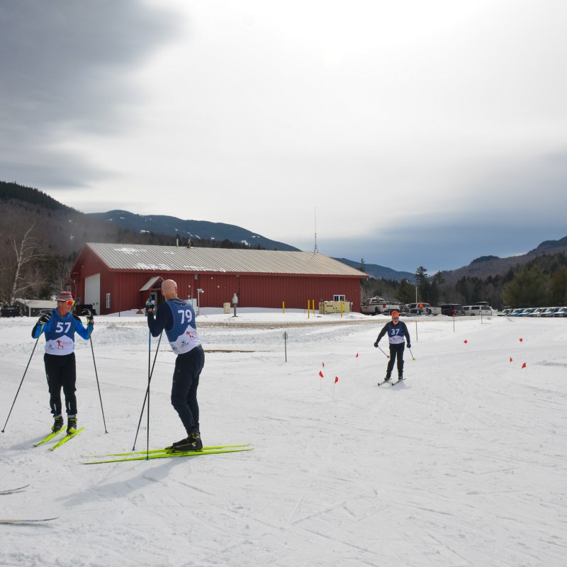 a group of people riding skis on top of a snow covered slope