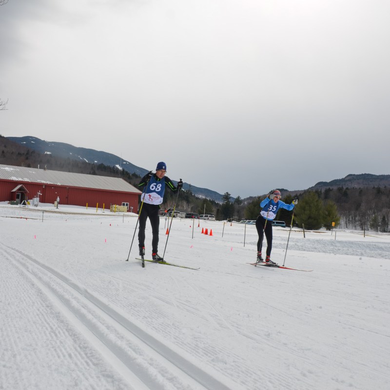 a group of people riding skis on top of a snow covered slope