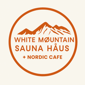 Logo with mountains, 'WHITE MØUNTAIN SAUNA HÅUS + NORDIC CAFE' in orange circle.